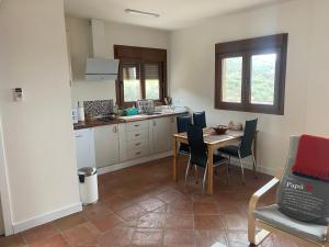 a kitchen with a table and chairs in a room at Villa Arriba in Periana +5 photos