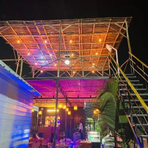 a person standing in the middle of a stage at night at Bayview Resort in Anjuna