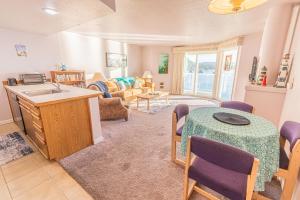 a kitchen and living room with a table and a couch at Dock of The Bay #306 in Lincoln City
