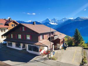 an aerial view of a house with mountains in the background at Chalet Lilo 4 Zimmer big View in Beatenberg