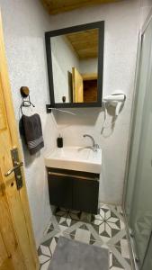 a bathroom with a sink and a mirror at Adalar Garden Bungalov in Kartepe