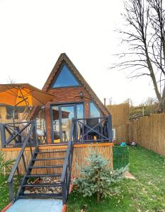 a small house with a porch and a deck at Adalar Garden Bungalov in Kartepe