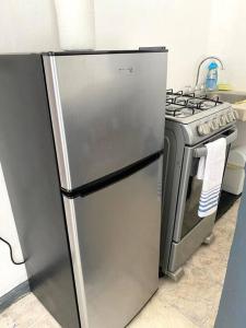 a stainless steel refrigerator in a kitchen next to a stove at Departamento con Servicios incluidos: El Ponto in Puerto Vallarta