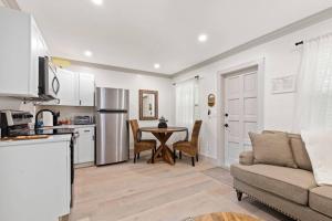 a kitchen and living room with a table and a couch at Newly Renovated 1BR apartment in the heart of WPB in West Palm Beach