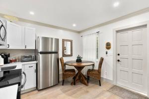 a kitchen with a table and a refrigerator at Newly Renovated 1BR apartment in the heart of WPB in West Palm Beach