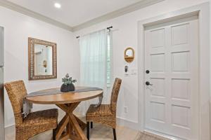 a dining room with a table and chairs and a door at Newly Renovated 1BR apartment in the heart of WPB in West Palm Beach +25 photos