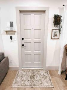 a white door in a living room with a couch at Lovely 1 Bedroom - Walk to Waterfront in West Palm Beach