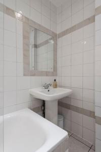a white bathroom with a sink and a mirror at Beautiful 1 Bed Flat close to Regents Park in London