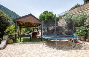 a swing set in a backyard with a gazebo at Rural house Janjić in Ploče