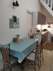 a kitchen with a table and chairs in a kitchen at Apartman Rosé in Eger