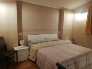 a bedroom with a large bed and two night stands at VILLA VIRGINIA in Piazza Armerina +20 photos