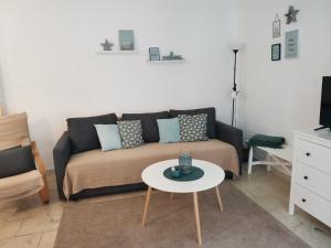 a living room with a couch and a table at Apartman Rosé in Eger
