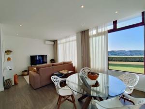 a living room with a glass table and a couch at Apartamento Mar & Sal in Mindelo