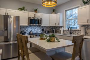 a kitchen with white cabinets and a large island at Luxury Beachside Vacation Getaway - OceanView, Movie Theatre, Mini Golf in Atlantic City