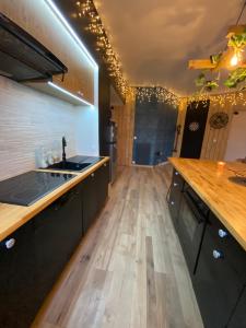 a kitchen with wooden floors and a counter top at - Le backpacker - logement atypique et spacieux en résidence avec ascenseur in Nevers