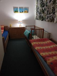 a bedroom with two twin beds and a dresser at Apartmány Česká Škola in Lipová