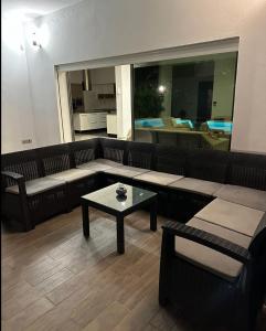 uma sala de estar com um sofá e uma mesa de centro em Villa avec piscine et Jacuzzi Tunis em Mornag