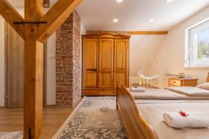 a bedroom with two beds and a brick wall at Vikendica Bjelašnica Lukavac in Bjelašnica