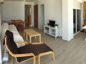 a living room with a bed and a table at PRIMERA LINEA DE PLAYA-CULLERA in Cullera