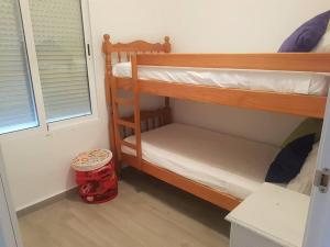 two bunk beds in a room with a window at PRIMERA LINEA DE PLAYA-CULLERA in Cullera