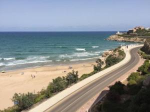 a road leading to a beach next to the ocean at PRIMERA LINEA DE PLAYA-CULLERA in Cullera +4 photos