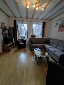 a living room with a couch and a table at Ferienhaus Königreich - Dreistegen in Monschau