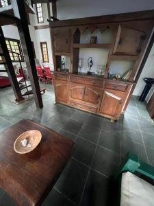 a kitchen with a wooden counter and a table at Casa próxima ao mar, Camburi. in São Sebastião