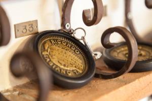 a close up of a pocket watch attached to a pair of scissors at Hotel Ricordo Du Parc in Tabiano