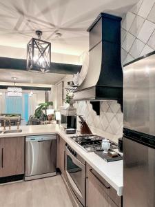 a kitchen with stainless steel appliances and a stove at Central Park Condesa in Mexico City