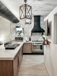a kitchen with wooden cabinets and a stove top oven at Central Park Condesa in Mexico City