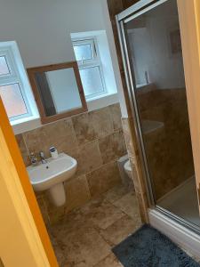 a bathroom with a sink and a shower at Westend Villas in Leicester