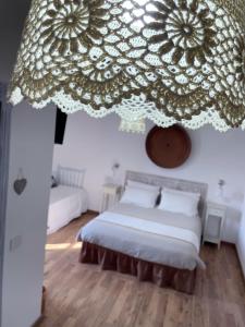 a bedroom with a bed with a large curtain above it at Torremana in Càbras
