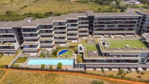 an aerial view of an apartment building with a swimming pool at Luxurious Ocean Dune Unit in Umhlanga