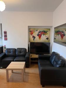 a living room with a couch and a tv at Westend Villas in Leicester