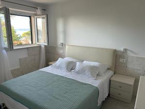 a bedroom with a bed with white sheets and pillows at Apartment Esperansa in Brela +34 photos