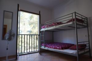 a bedroom with two bunk beds and a balcony at Chalet Font de Sa Cala in Font de Sa Cala