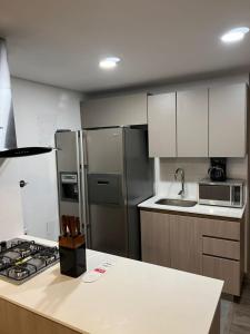 a kitchen with stainless steel appliances and a counter top at Retirada in Rionegro