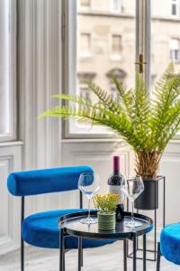 a table with two glasses and a bottle of wine at Downtown Delight - Erzsébet BLVD - 13 PPL in Budapest