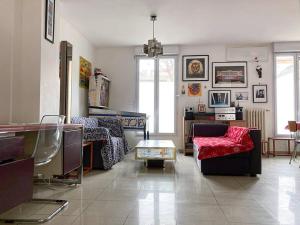 a living room with a couch and a table at 3 bedroom House very close to Paris in Pantin +17 photos