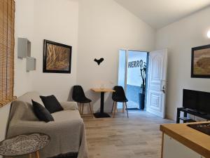 a living room with a couch and a table at Hierro in Frontera