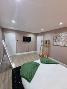 a bedroom with a large bed and a flat screen tv at Premier inn mattresses SKY SPORTS & Netflix- sleeps 6 in Middleton +17 photos