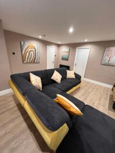 a living room with a large blue couch at Premier inn comfort mattresses - sleeps 6 in Middleton