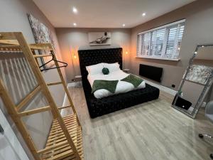 a small bedroom with a bed and a staircase at Premier inn comfort mattresses - sleeps 6 in Middleton