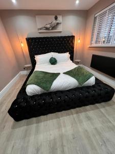 a large bed with a black headboard in a bedroom at Premier inn comfort mattresses - sleeps 6 in Middleton