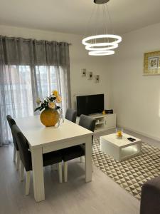 a living room with a white table and chairs at Apartamento Palomar in Pombal