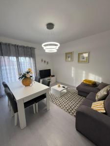 a living room with a couch and a table at Apartamento Palomar in Pombal