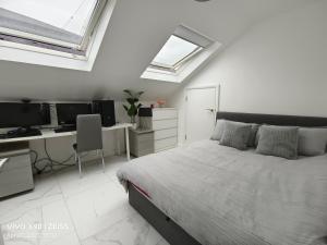 a bedroom with a bed and a desk with a computer at Shared House - 10 mins from Piccadilly Station/Man Uni/O2 Apollo in Manchester