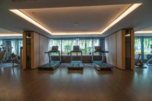 a gym with several exercise equipment in a room at Luxury & Bright 2BR Chianti Tower Mall Access in Jakarta