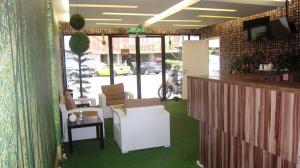 a room with a bar with chairs and a table at Dream Garden Hotel in Klang