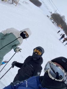 a group of people standing on a snow covered slope at Harmony Resort in Tsaghkadzor